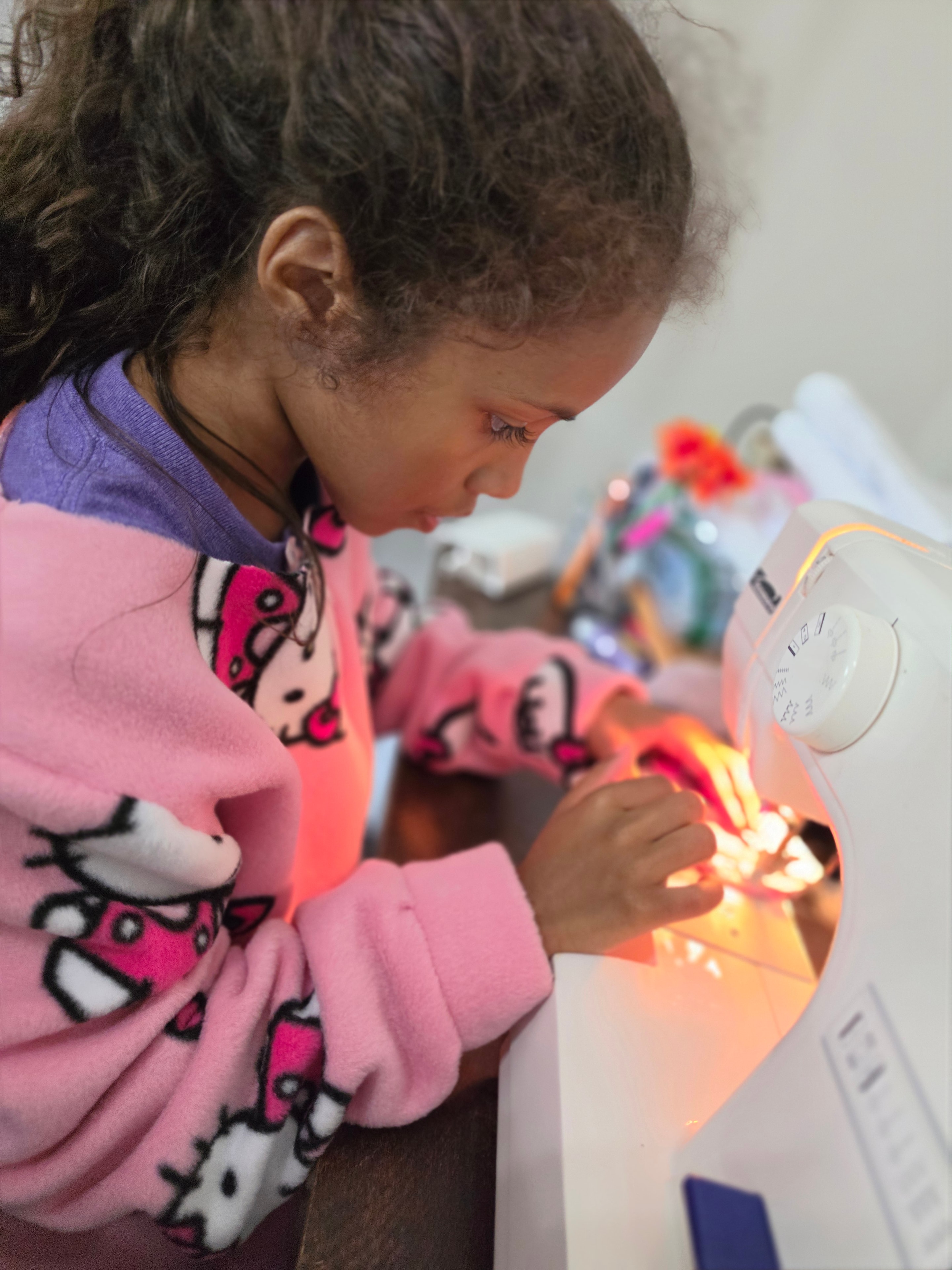 Focused at the sewing machine — every stitch made with intention